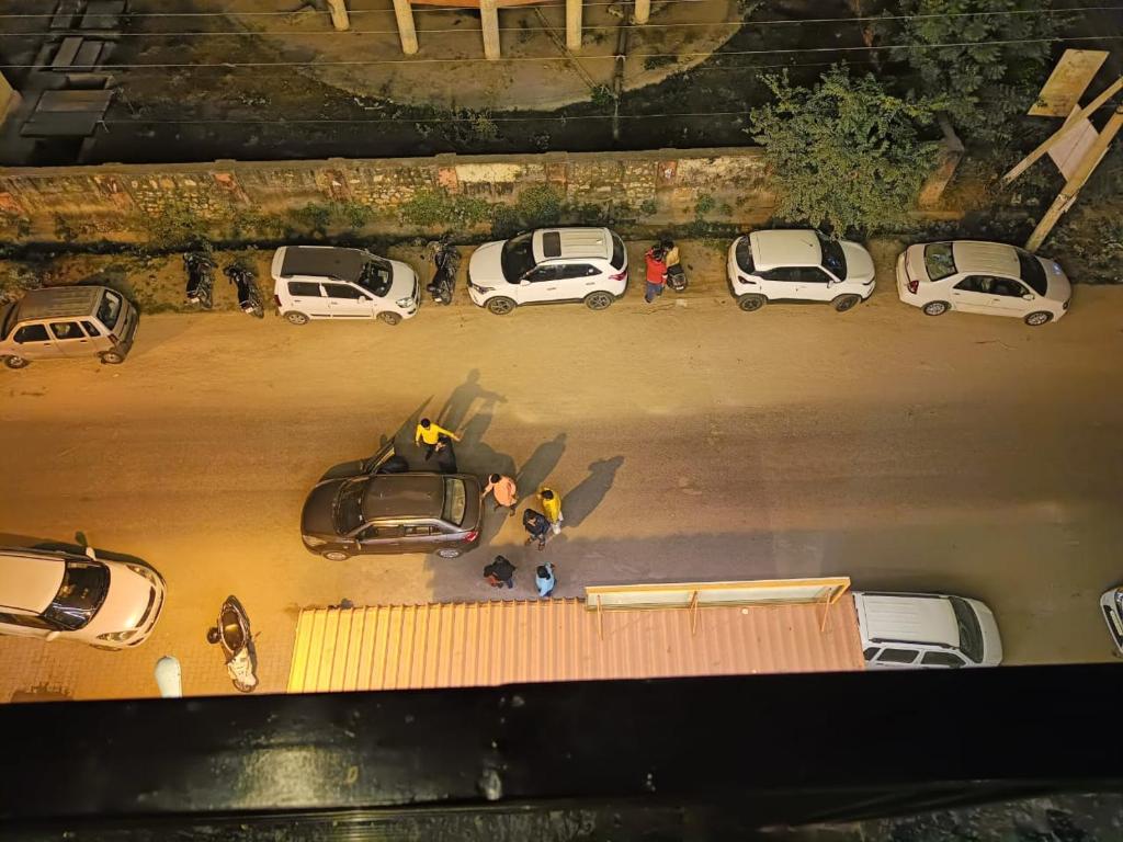 an overhead view of cars parked in a parking lot at Hotel Greenoz in Jaipur