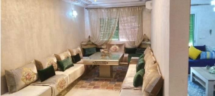 sala de estar con sofá y mesa en مسكن الراحة, en Tafza