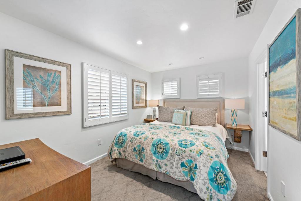 a bedroom with a bed and a desk at Villa Lanai at the Sunset Cove Villas in Laguna Beach