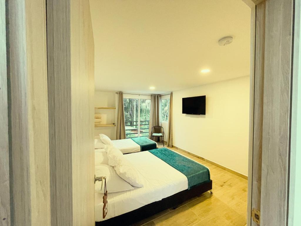 Postel nebo postele na pokoji v ubytování Hotel Campestre Villa Mary