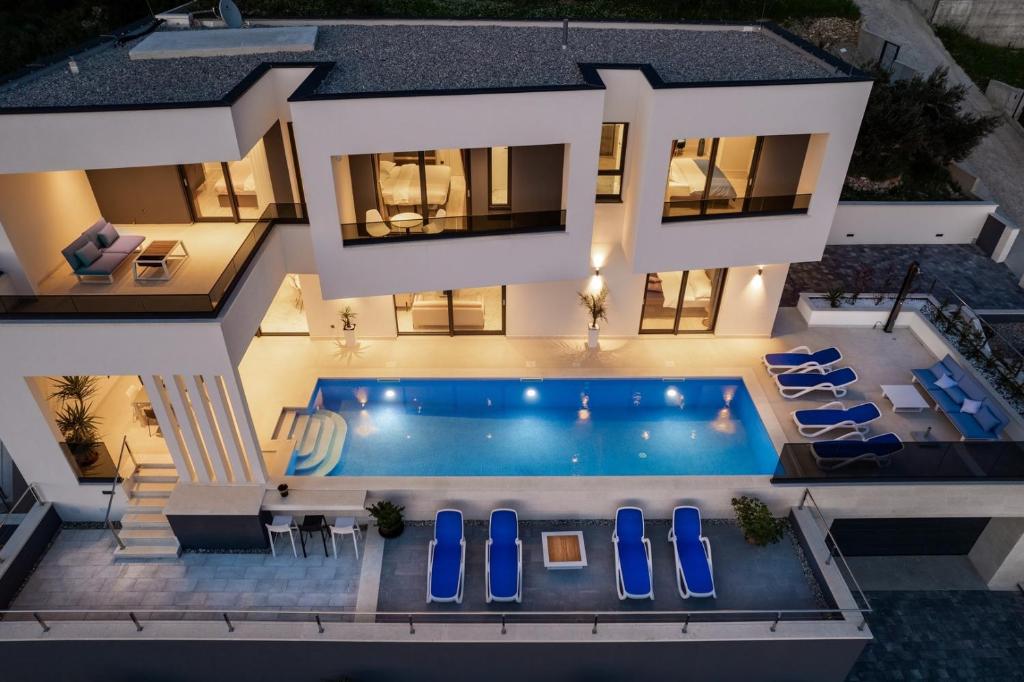 an aerial view of a house with a swimming pool at Luxury Villa Sagnia, 4 en-suite bedrooms, sea views in Makarska