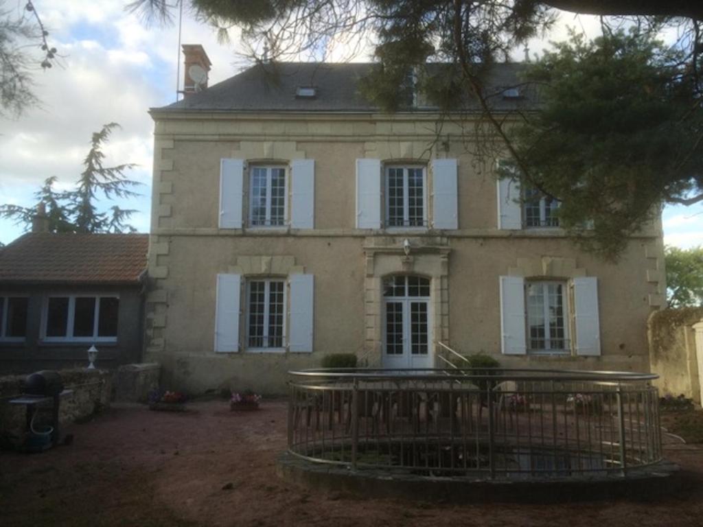 an old house with a gate in front of it at Gite de Saint Jean in Saint-Jean-de-Thouars