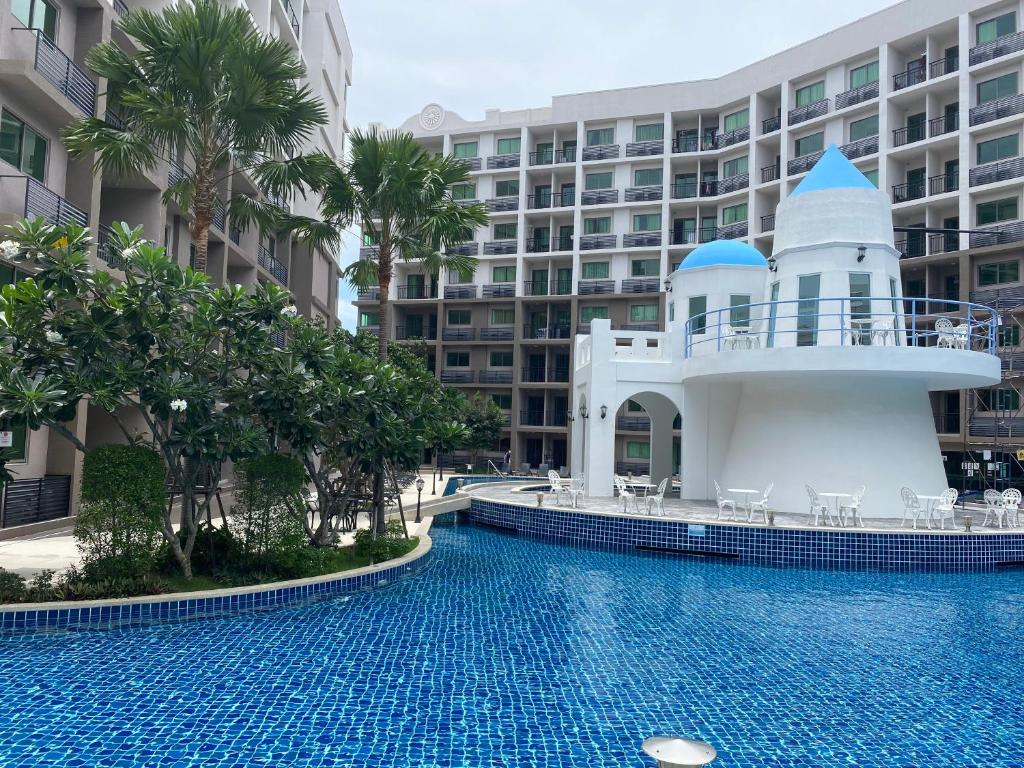 a swimming pool in front of a building at Arcadia Beach Continental in Pattaya South