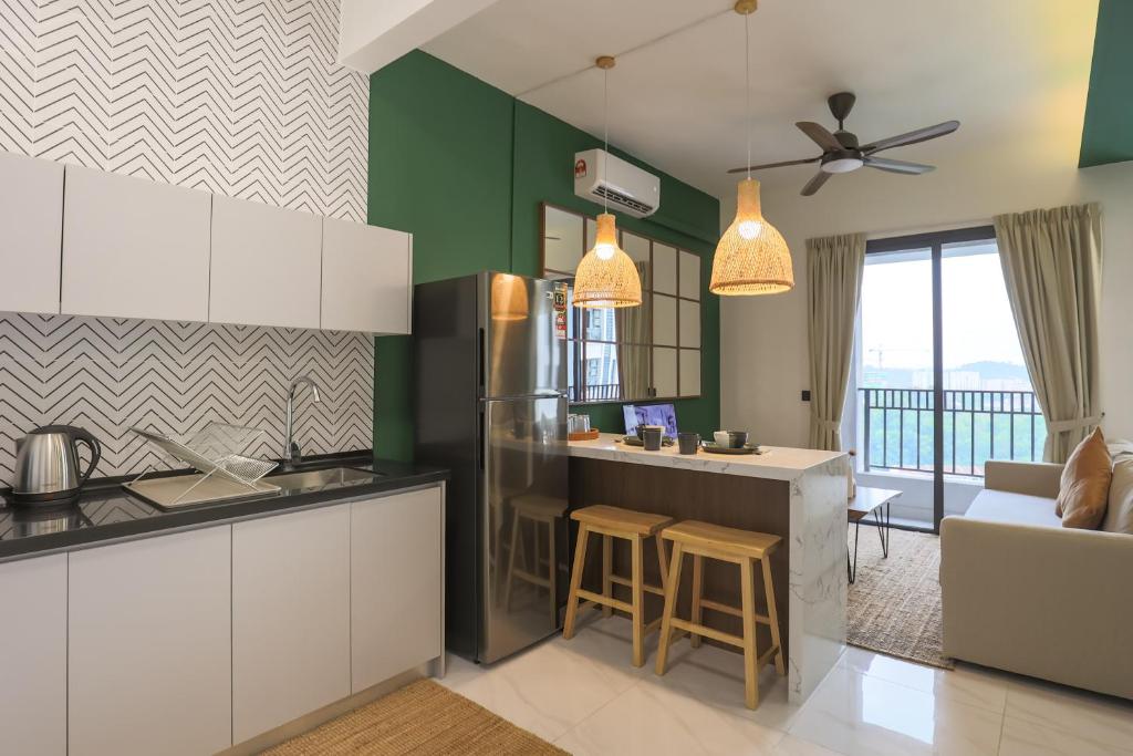 a kitchen with a refrigerator and a counter top at Peaceful Studio w Pool for 3 Pax - Seri Kembangan in Seri Kembangan