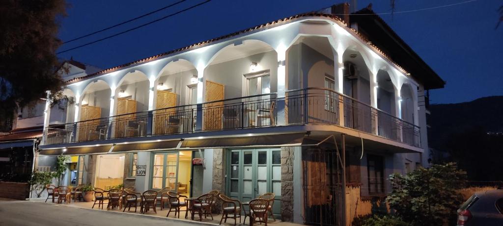 a building with chairs and tables on the balcony at Hotel Ilion in Petra