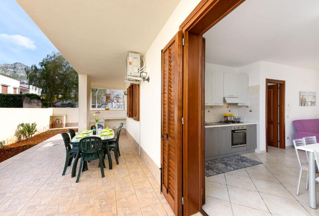 a kitchen and dining room with a table and chairs at Bedda Luna Villa in San Vito lo Capo