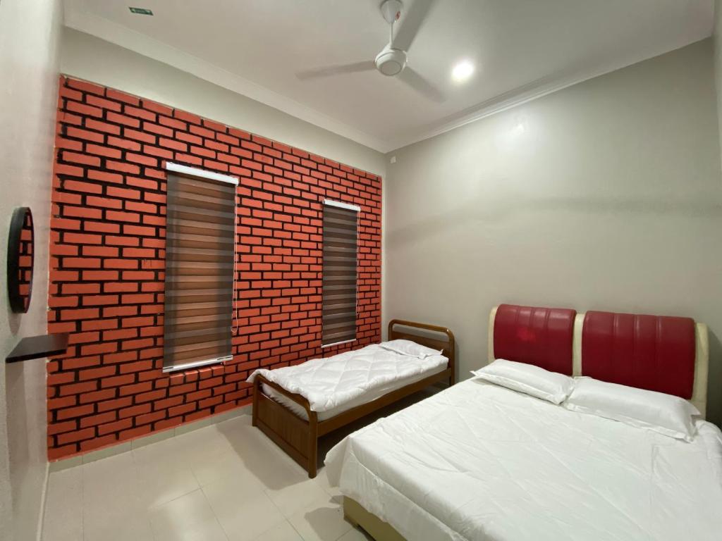 Postel nebo postele na pokoji v ubytování Sasuka Guesthouse (Muslim Sahaja)