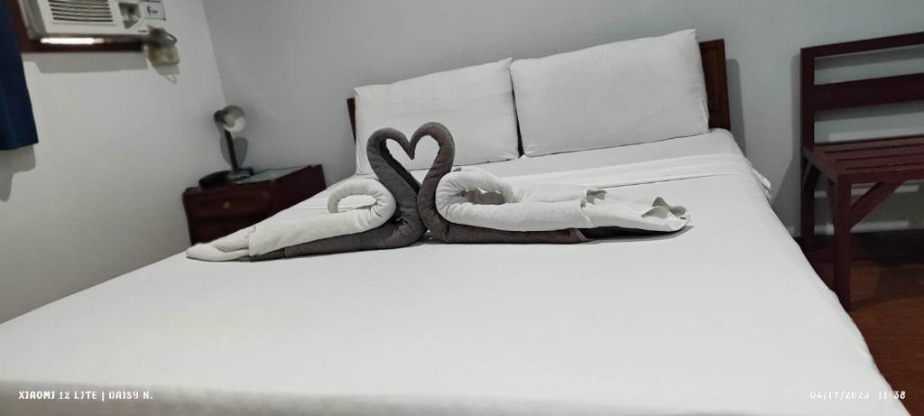 a bed with two swans made out of towels at duck inn manila in Manila