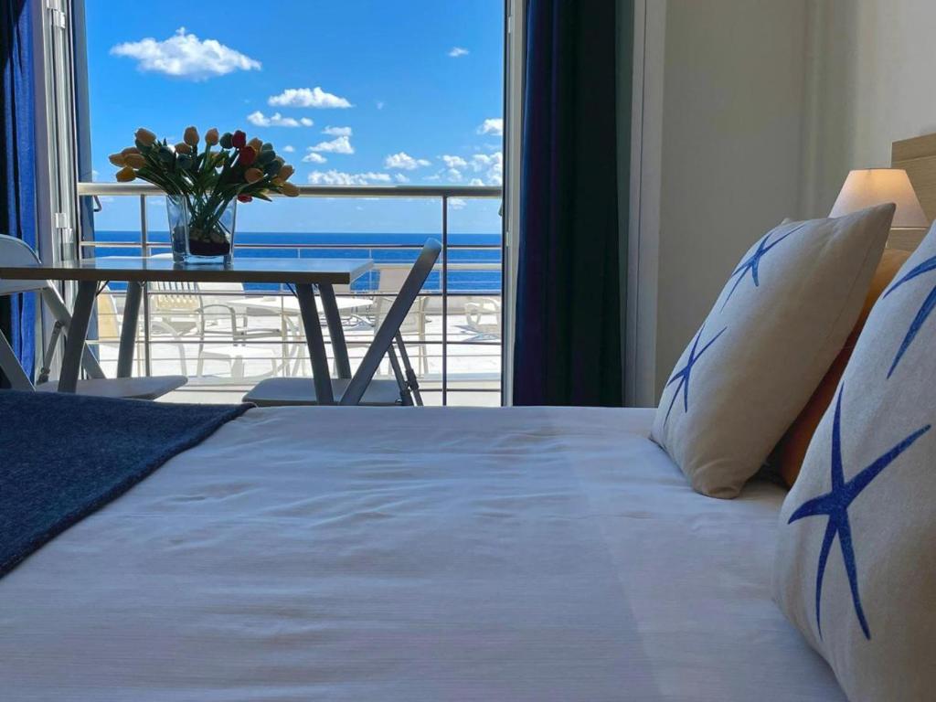 sypialnia z łóżkiem i widokiem na ocean w obiekcie Residence Stella Marina w mieście Ustica
