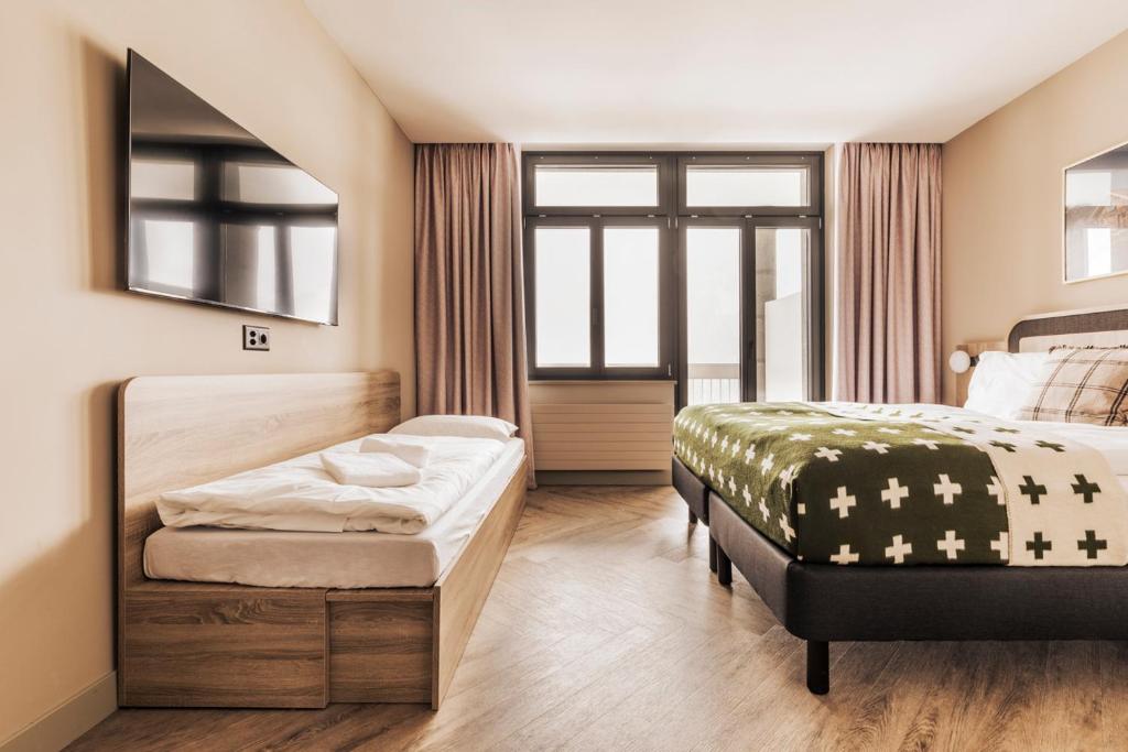 Una cama o camas en una habitación de Hotel Altein Arosa, a Faern Collection Resort