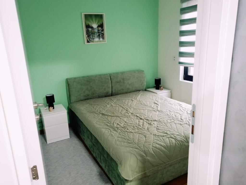 a bedroom with a bed and two night stands at Apartman Ekvilibrijum in Zlatibor