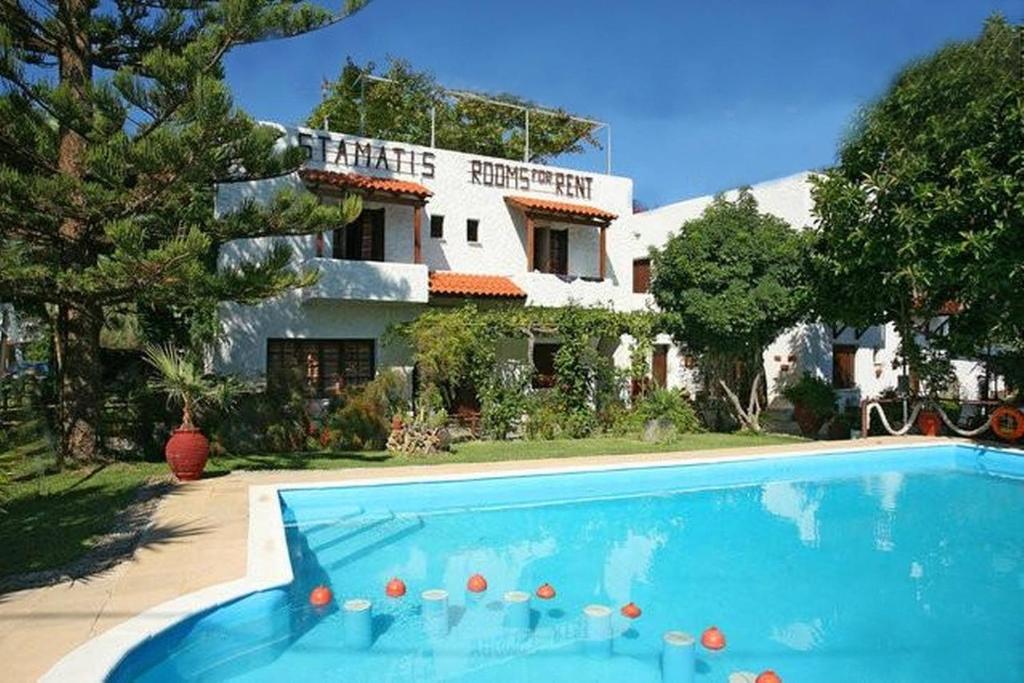 a house with a swimming pool in front of a house at Summer Lodge in Maleme