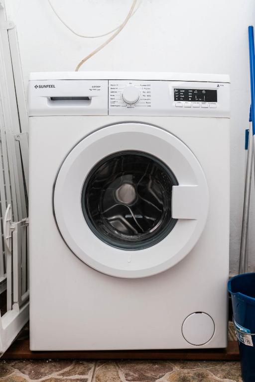 a white washing machine sitting in a room at Las Casitas de Corralejo in Corralejo