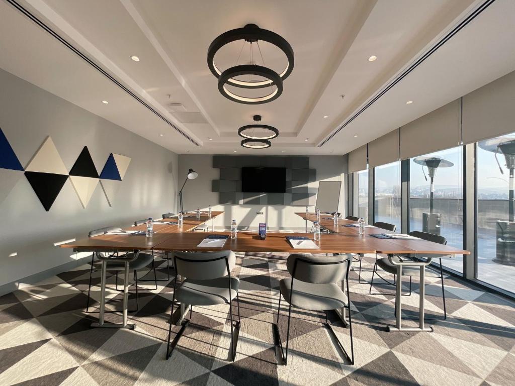 a dining room with a large wooden table and chairs at Holiday Inn Express - Ankara - Airport by IHG in Ankara