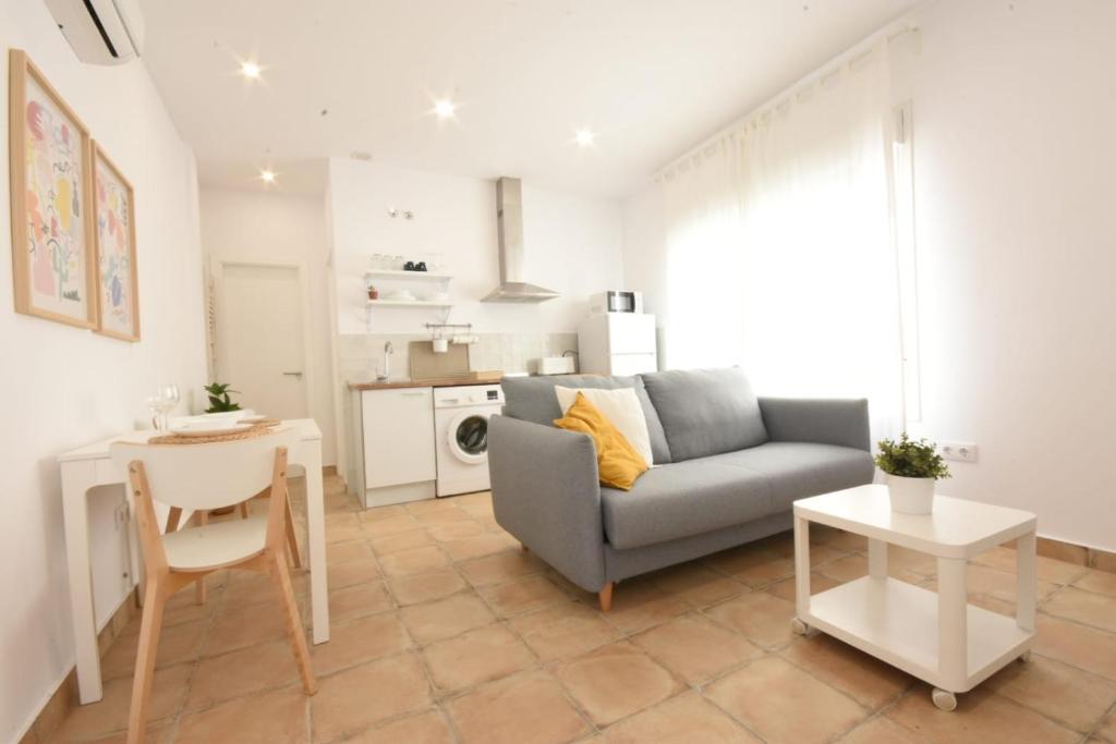 a living room with a couch and a table at BITA Home in Barbate