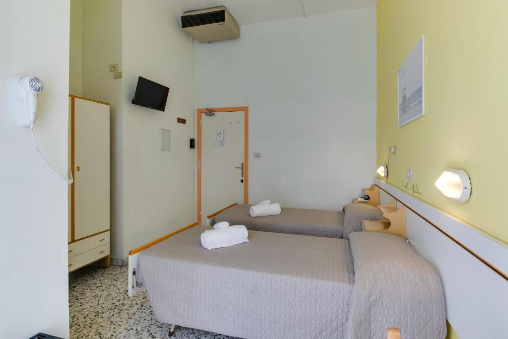 Postel nebo postele na pokoji v ubytování Hotel Villa Merope