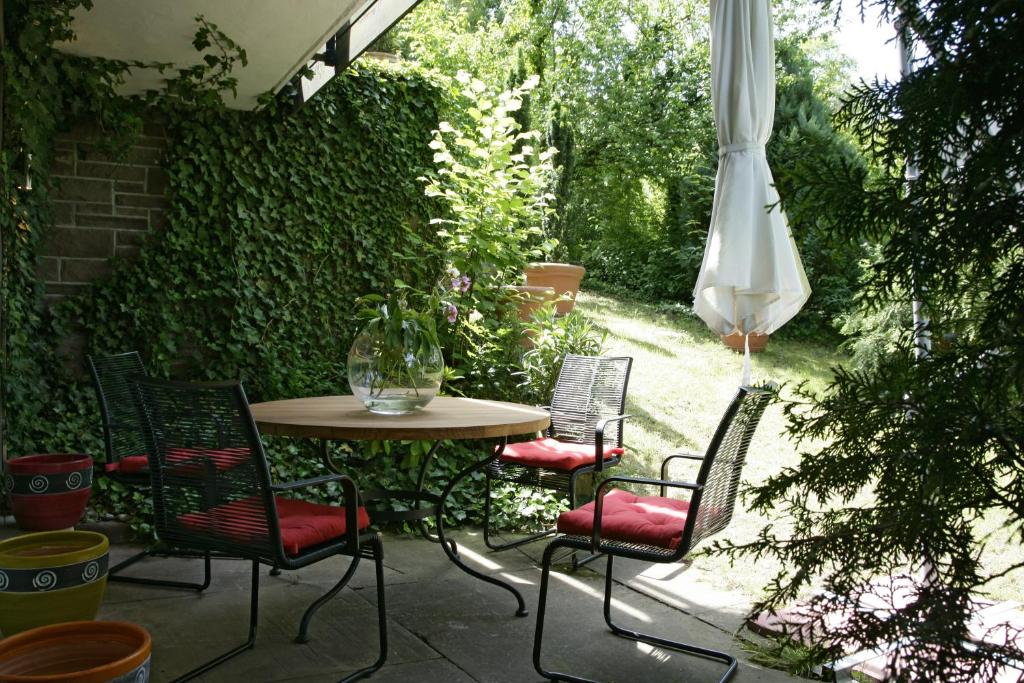 a patio with a table and chairs and an umbrella at Apartment Schlossberg in Tübingen