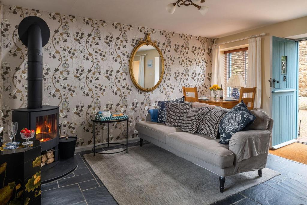 a living room with a couch and a fireplace at Puffin Cottage in Ilfracombe