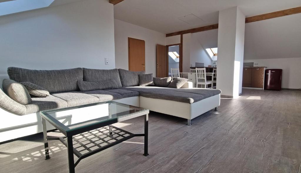 a living room with a couch and a glass table at Haus Stella am Meer in Rerik