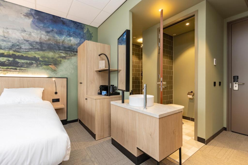 Postel nebo postele na pokoji v ubytování Fletcher Hotel-Restaurant Marknesse