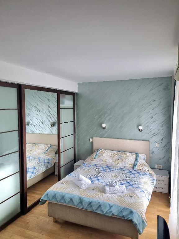 a bedroom with two beds and a mirror at Dixy 2 in Belgrade