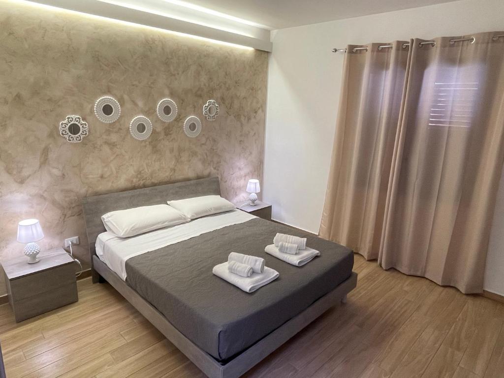1 dormitorio con 1 cama y 2 toallas en Testa di Moro, en Marsala