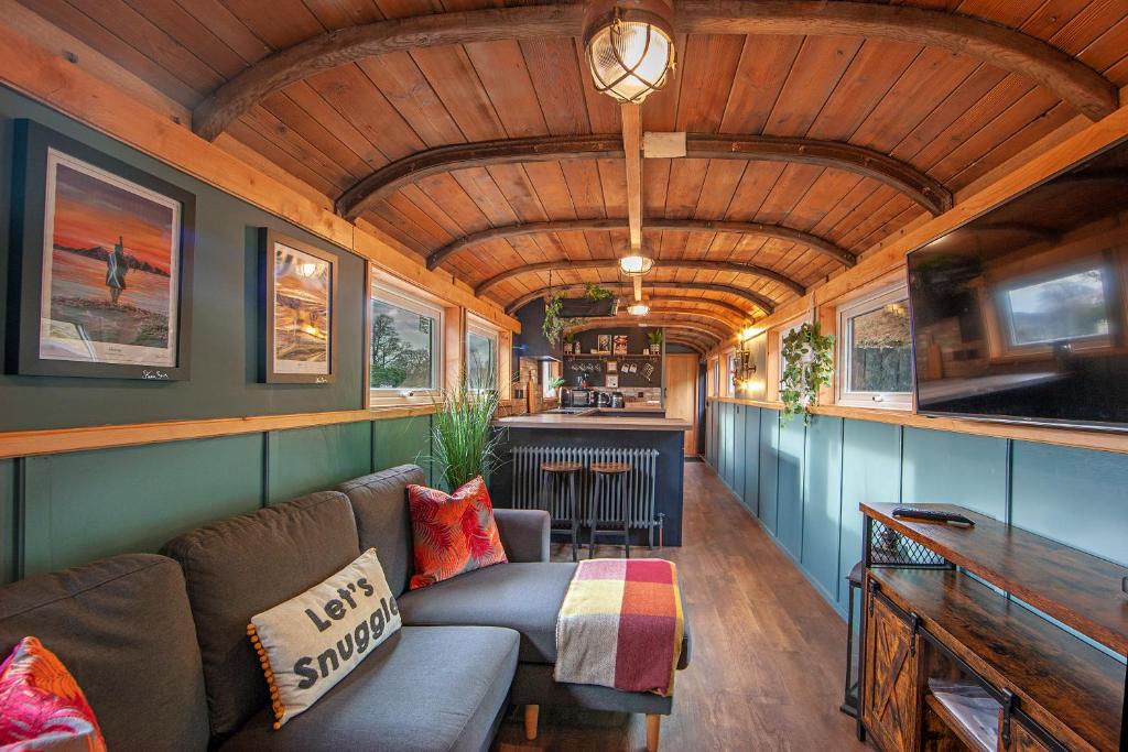 a living room of a train car with a couch at The Carriage at Creagan in Creagan