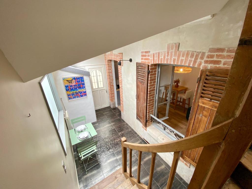 an overhead view of a staircase in a house at P&#39;tite maison du Parc in Orléans