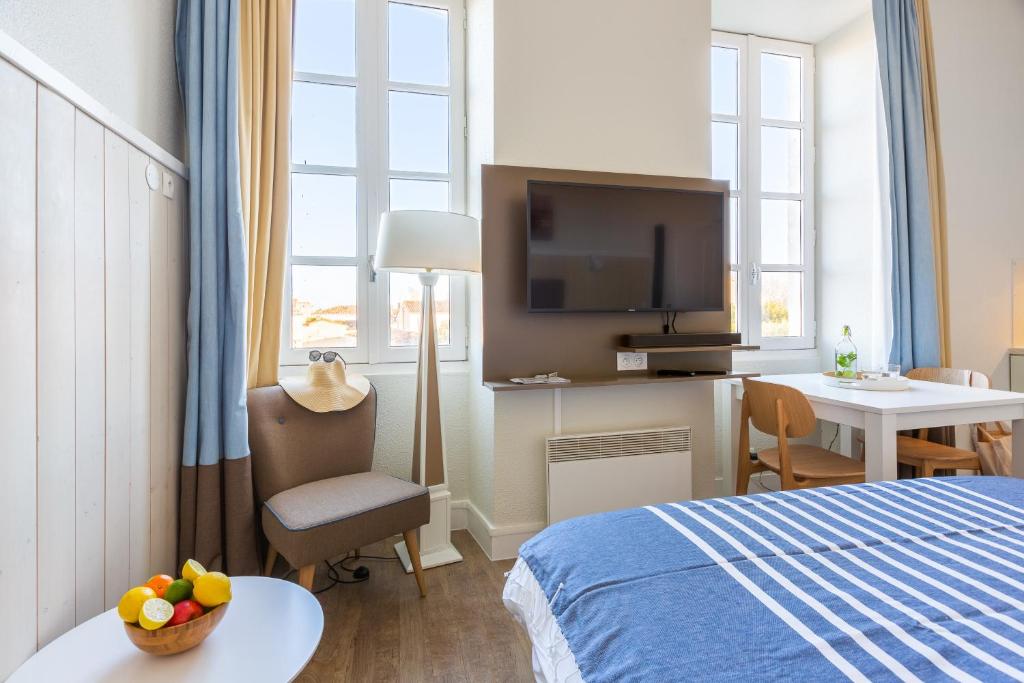 Postel nebo postele na pokoji v ubytování Résidence Pierre & Vacances Le Palais des Gouverneurs
