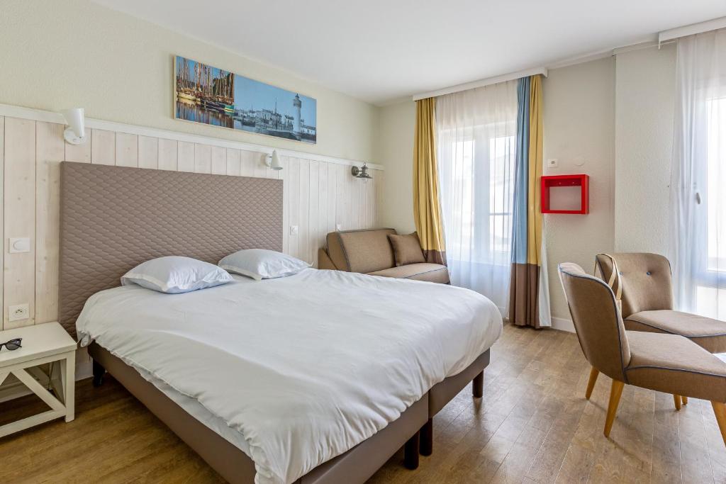 Postel nebo postele na pokoji v ubytování Résidence Pierre & Vacances Le Palais des Gouverneurs