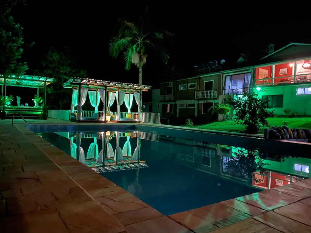a swimming pool in front of a house at night at Hotel La Bella Toscana - Exclusive Hotel in Águas de Lindóia