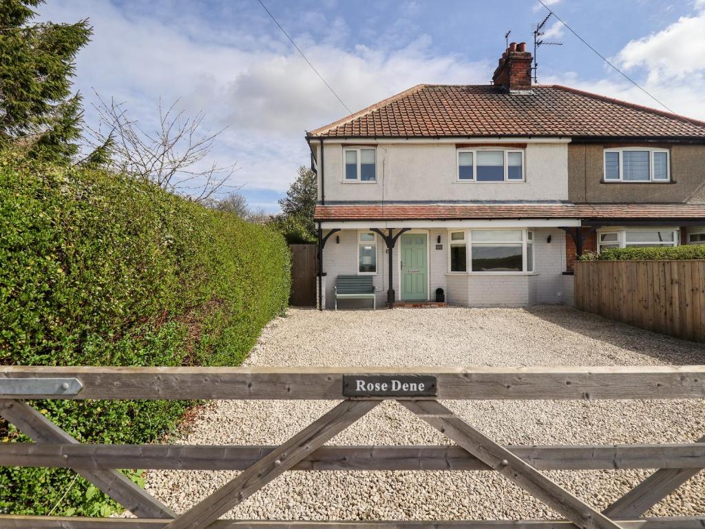 a house with a fence in front of it at Rose Dene in Brough