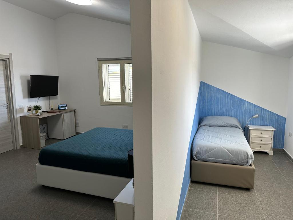 Postel nebo postele na pokoji v ubytování LXR Rooms Carloforte