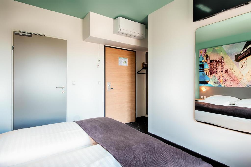 Postel nebo postele na pokoji v ubytování B&B Hotel Graz-Hbf