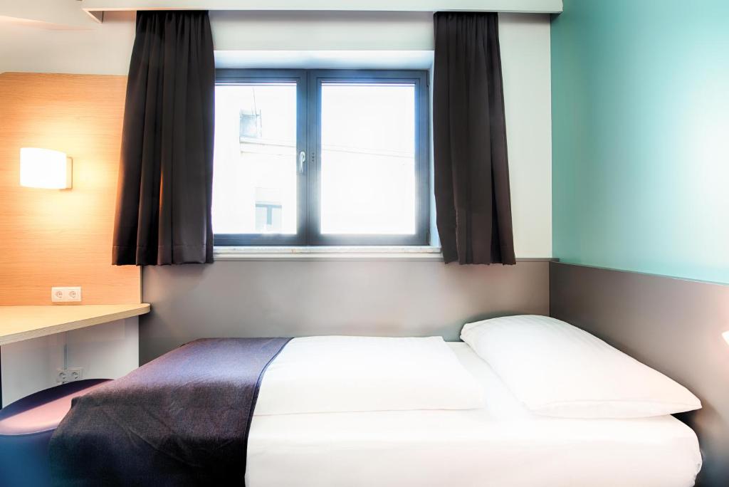 Postel nebo postele na pokoji v ubytování B&B Hotel Graz-Hbf