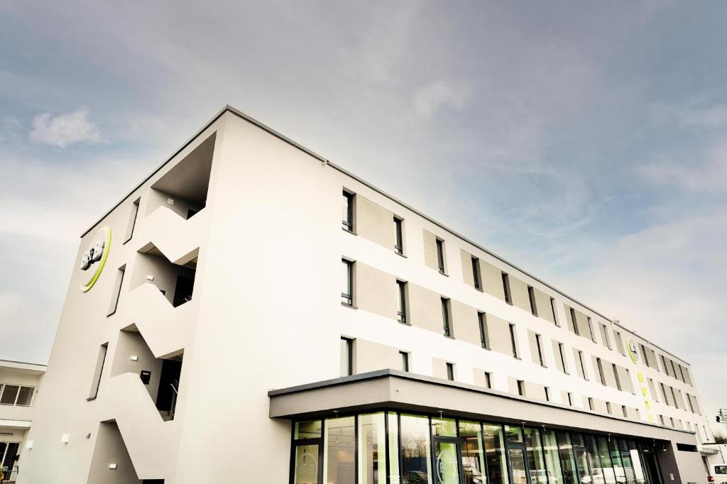 a white building with a lot of windows at B&B Hotel Kehl in Kehl am Rhein