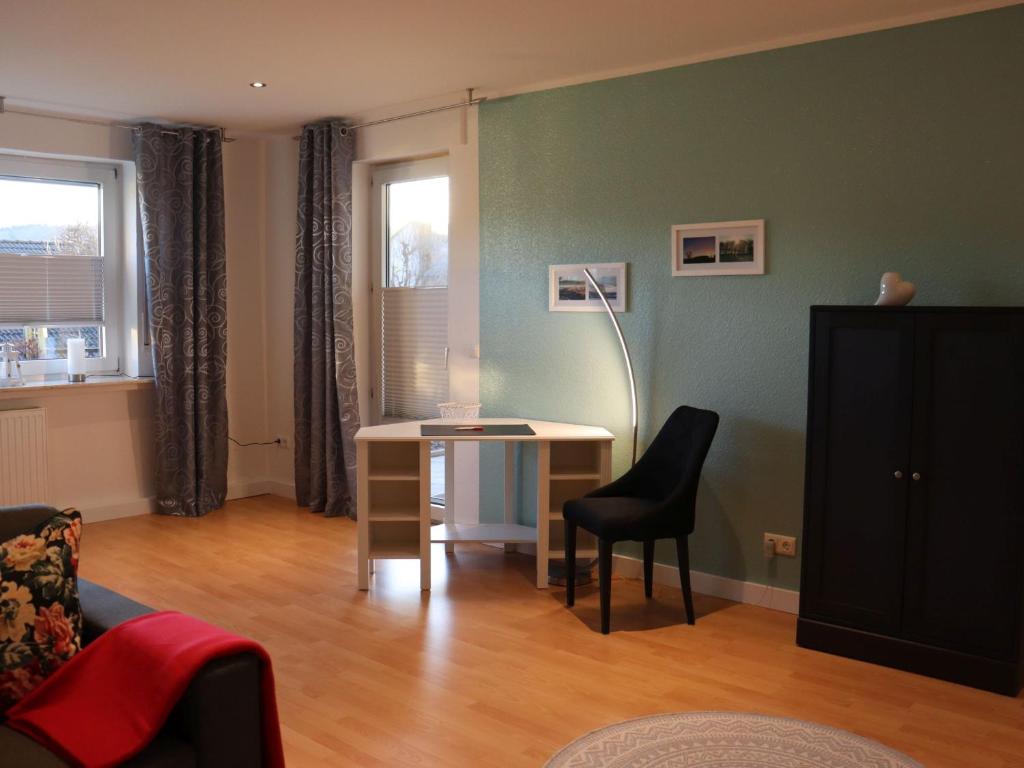 een woonkamer met een tafel en een stoel bij Ferienwohnung Sterl 13 in Herscheid