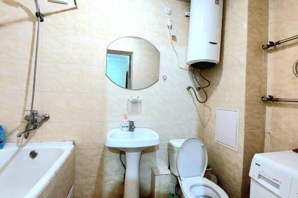 a bathroom with a sink toilet and a mirror at Аэропорт Астана 5 минут юг1 in Astana