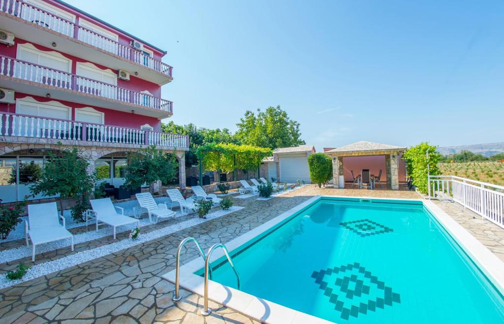 a swimming pool in front of a hotel at Villa Dalia in Mostar