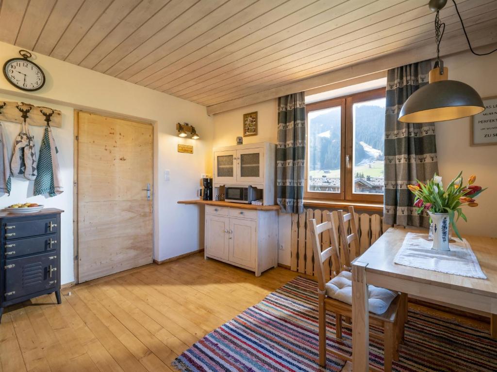 a kitchen and dining room with a table and chairs at Im Riederhof in Going am Wilden Kaiser