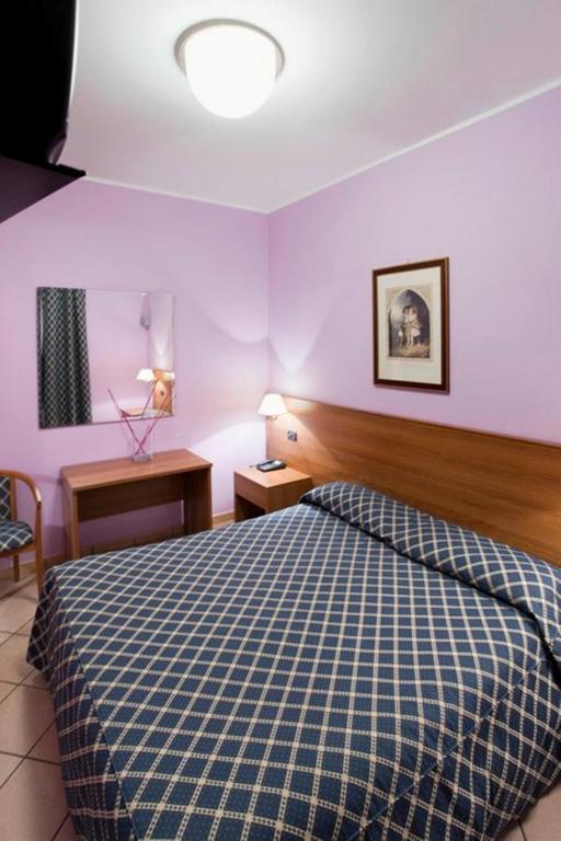 Postel nebo postele na pokoji v ubytování Hotel Scrivano