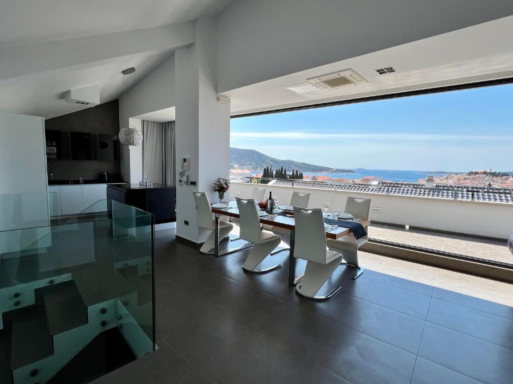 a kitchen and dining room with a view of the ocean at Luxury Laurus Penthouse with awesome sea view in Primošten