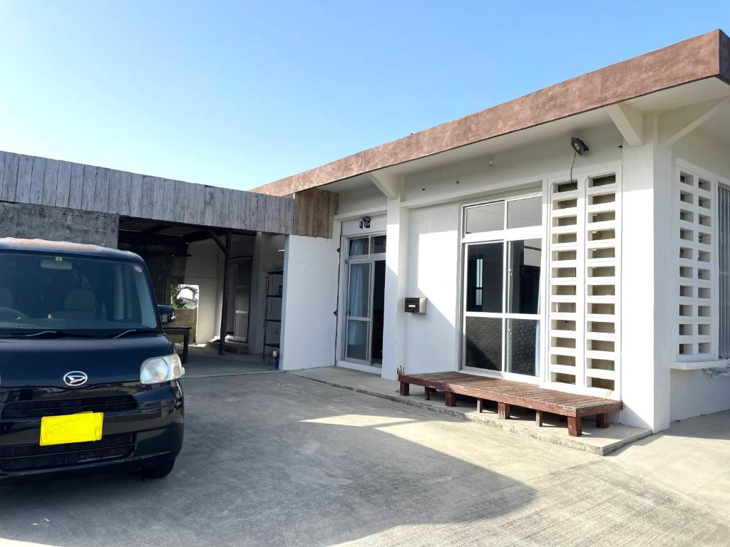 a van parked in front of a building at 一棟貸しの宿 民宿せいじん家 in Miyako-jima