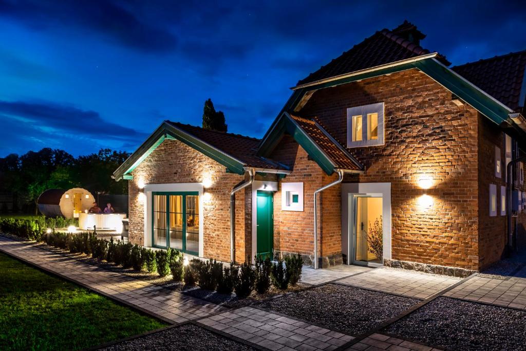 a brick house with lights on it at night at Kadyny Apartments 37B in Kadyny