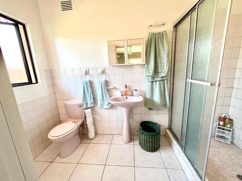 a bathroom with a toilet and a sink and a shower at Granny Flat &Solar in Ramsgate