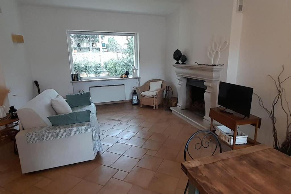 a living room with a couch and a fireplace at Racconto di Puglia - Selva di Fasano in Selva di Fasano