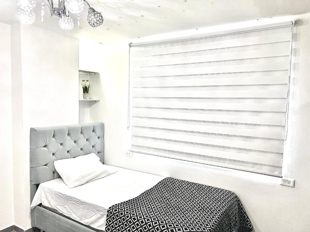 Llit o llits en una habitació de Apartamento Rio Guatapurí