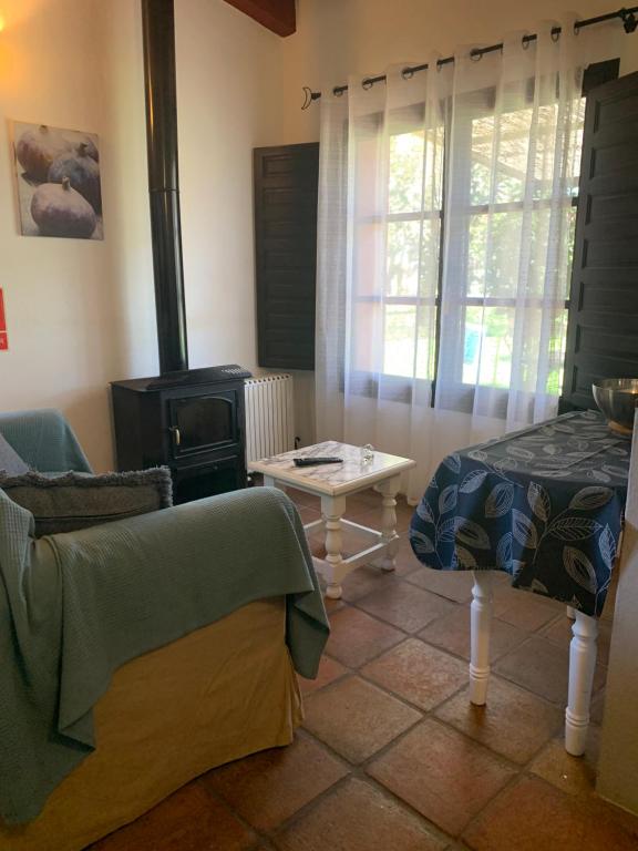 a living room with a stove and a couch at Molino El Mastral in Tarifa