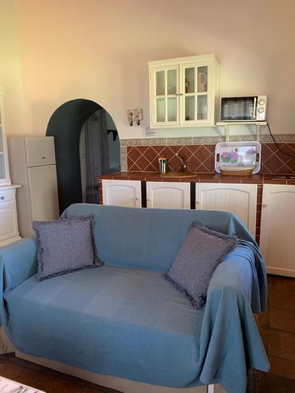 a blue couch with two pillows in a kitchen at Molino El Mastral in Tarifa