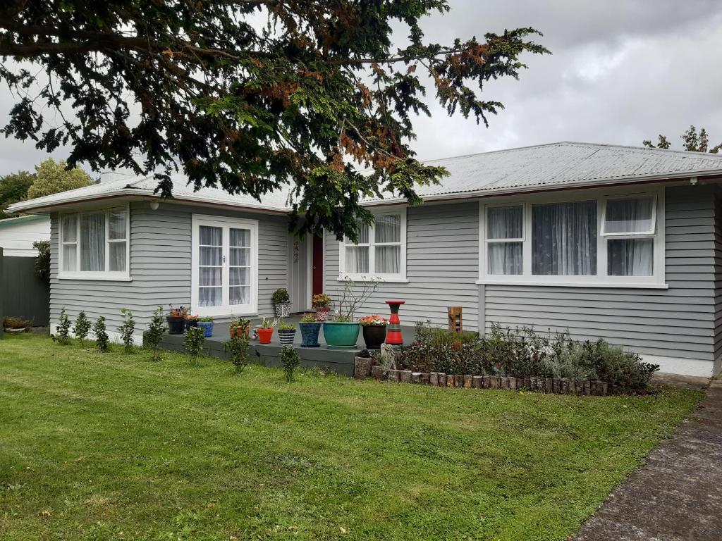 a house with a garden in front of it at Happy Space in Waihi